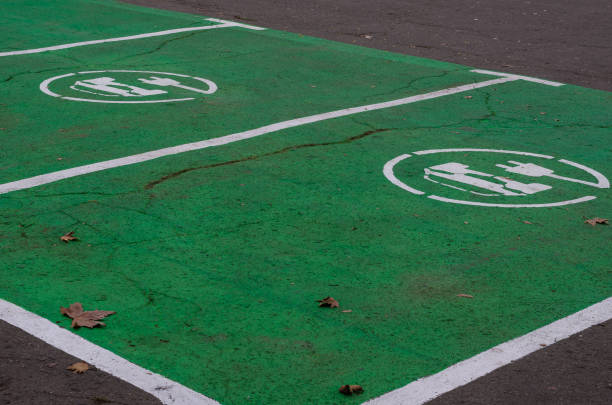 istock Electric vehicle refueling sign on asphalt. 1183105849
