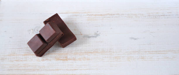 istock Dark Chocolate Bars on Wooden Background 1183106800