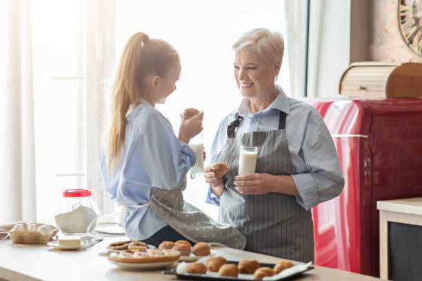 istock Friendly girl and granny having conversation while lunch time 1183107818