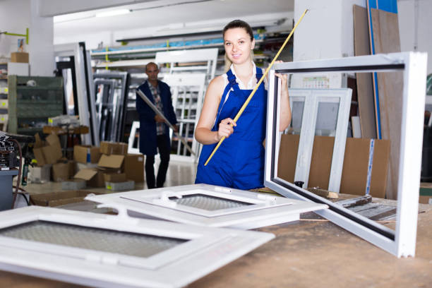 istock female worker measuring metal-plastic window frame in workshop 1183109179