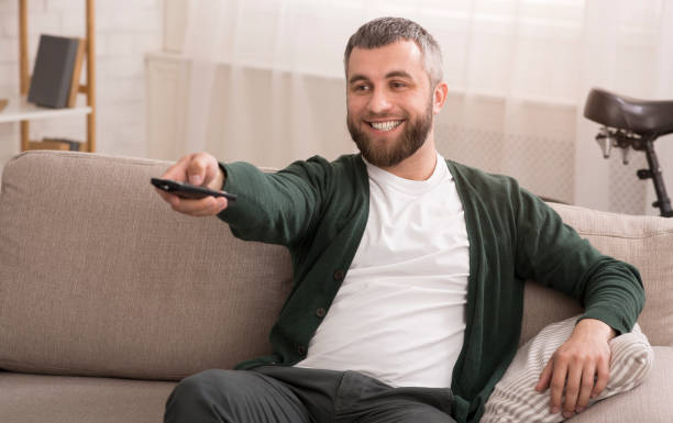 istock Cheerful man watching nice movie at home on weekend 1183109223