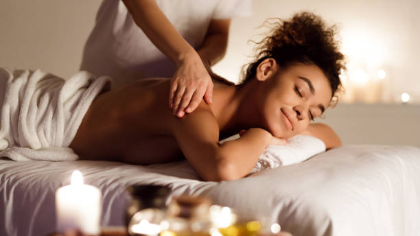 istock Millennial afro lady enjoying back massage in spa 1183110278