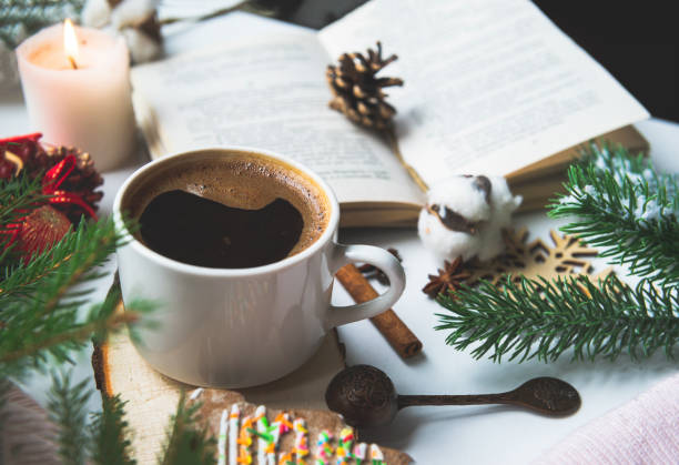 istock 1 Cup black coffee, fir branches, candle, open book, cone, cotton branch, 1183110753