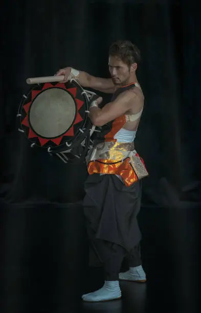 Photo of Full length portrait of a Japanese drummer Taiko