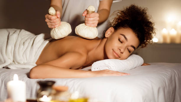Oriental therapy. Lady receiving herbal massage at spa center Oriental therapy. Lady receiving herbal massage at spa center, relaxing with closed eyes ice pack photos stock pictures, royalty-free photos & images