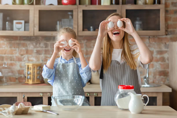 istock Mom and daughter making egg glasses while cooking 1183113951