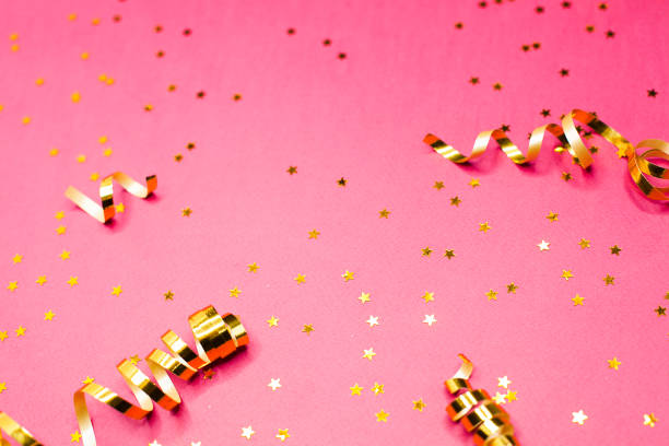 istock Golden decorations and sparkles on pink background 1183114514