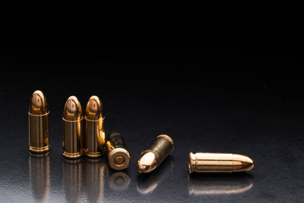 istock Bullet isolated on black background with reflexion. Rifle bullets close-up on black back. Cartridges for rifle and carbine on a black. 1183116366