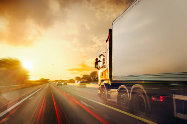 lorry traffic transport on motorway in motion - semi truck cargo container mode of transport horizontal imagens e fotografias de stock