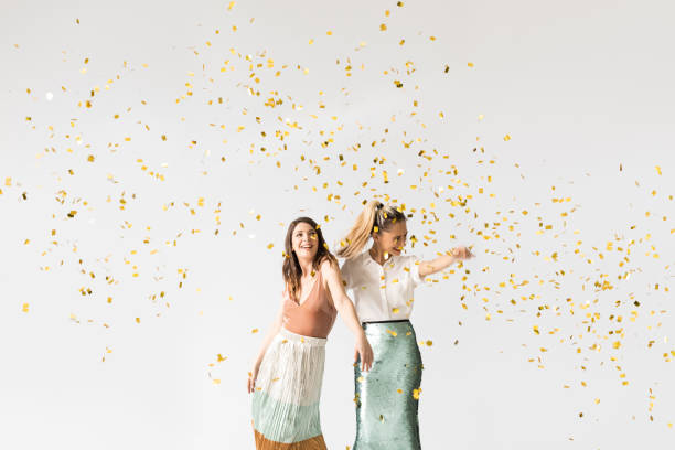 istock Party Girls Dancing Under Confetti 1183120205