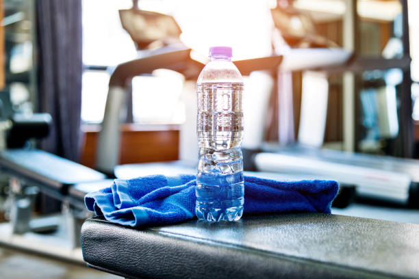 Towel And A Bottle Of Water In Gym Stock Photo - Download Image Now - Gym,  Health Club, Backgrounds - iStock