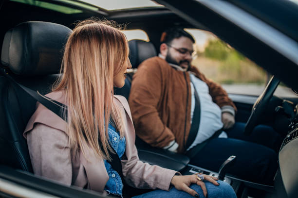 istock Two friends fastening their seatbelts 1183124436