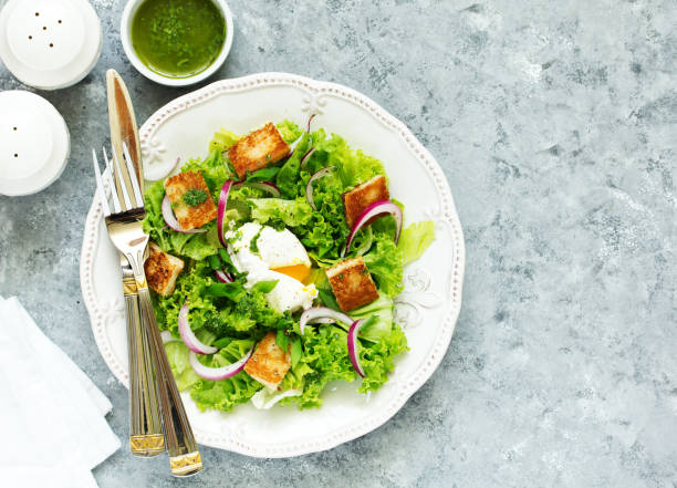 istock Spring salad with poached egg and crispy croutons. View from above. 1183125507