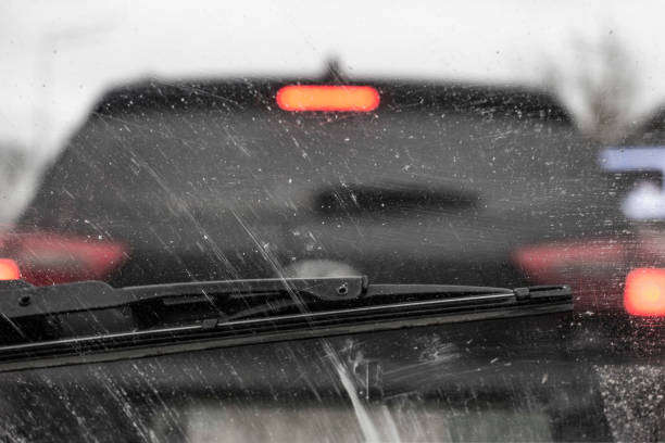 Windshield wipers from inside of car, season rain.