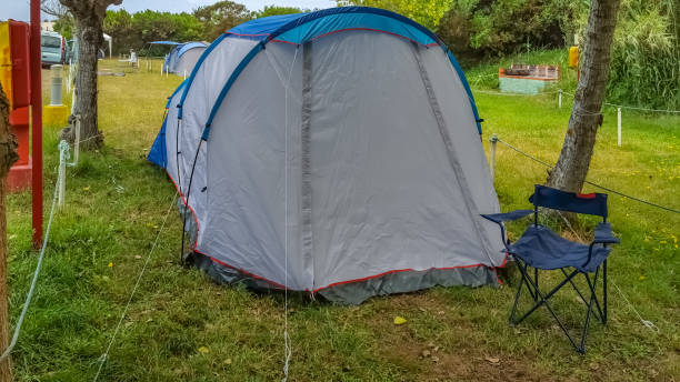 istock View with camping tent mounted on the grassy ground in campsite 1183126145