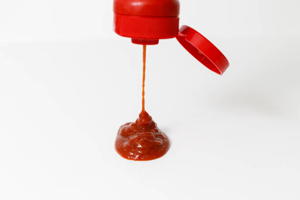 istock pouring ketchup on white background 1183126753