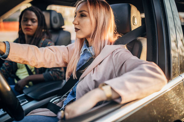 istock young women driving in the car 1183128379