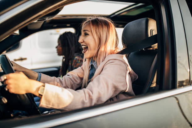 istock young women driving in the car 1183128954
