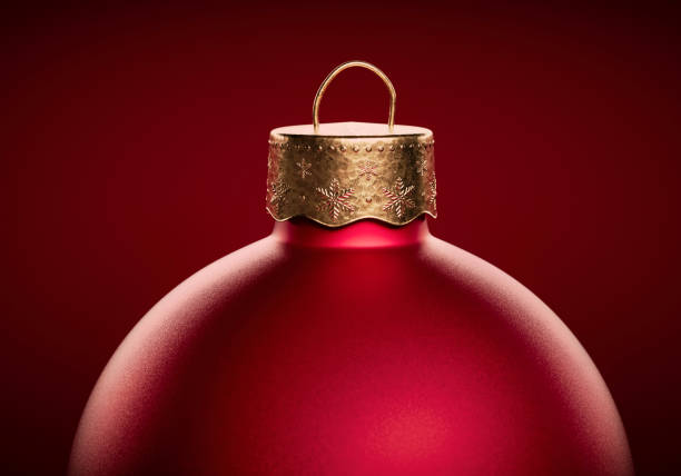 Red christmas ball close-up against dark red background. Template for greeting card or design. With Copy space.