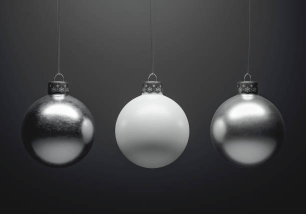 istock Exciting Metallic christmas baubles hanging in front of dark grey background. 1183129070