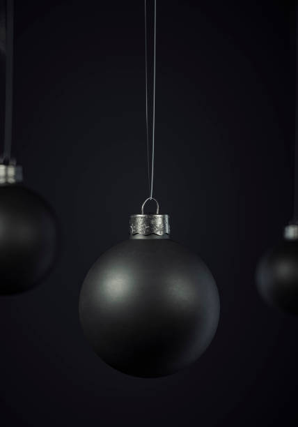 istock Matte black Christmas ball hanging centered on a black background 1183129253