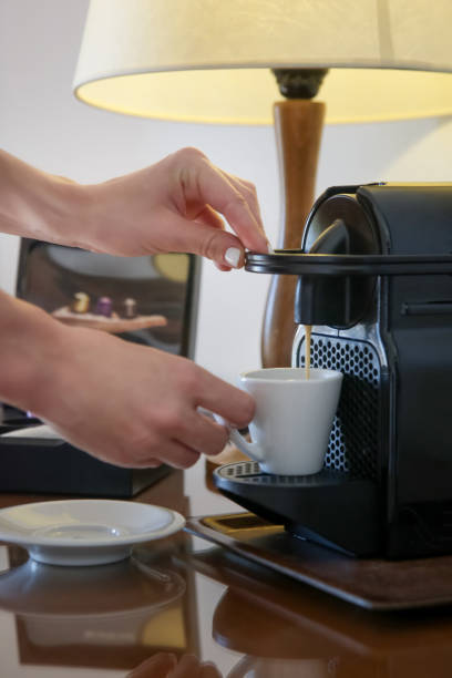 istock Woman preparing a fresh coffee with a coffee maker machine 1183130029