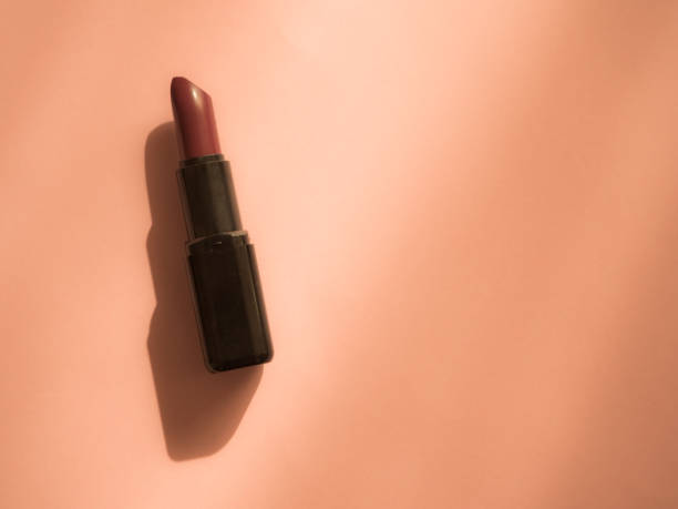 istock Woman lipstick on orange background with copy space 1183132893
