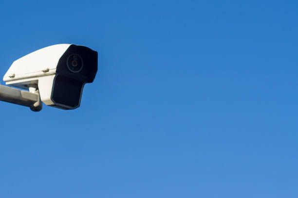 istock Surveillance camera against blue sky stock photo 1183134244