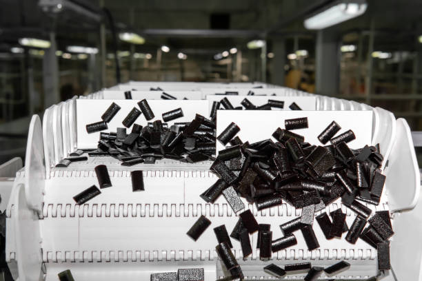 sliced fruit pastilles on the conveyor of a confectionery factory against a blurry shop background"n"n - pastilles imagens e fotografias de stock