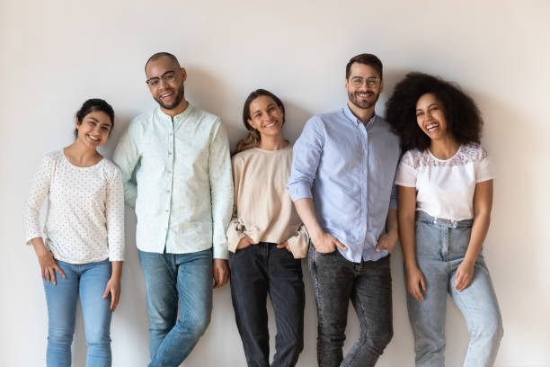 istock Portrait of smiling young diverse people standing in row 1183136535