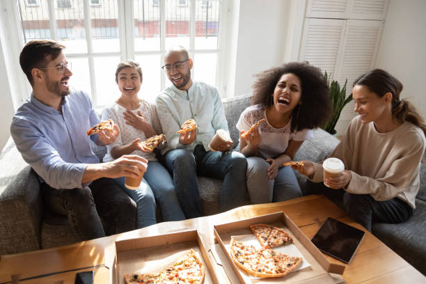 istock Happy diverse friends eating pizza, having fun together 1183136564