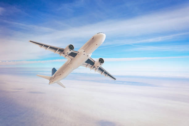 istock Air plane flies in the sky clouds fly high. 1183142024