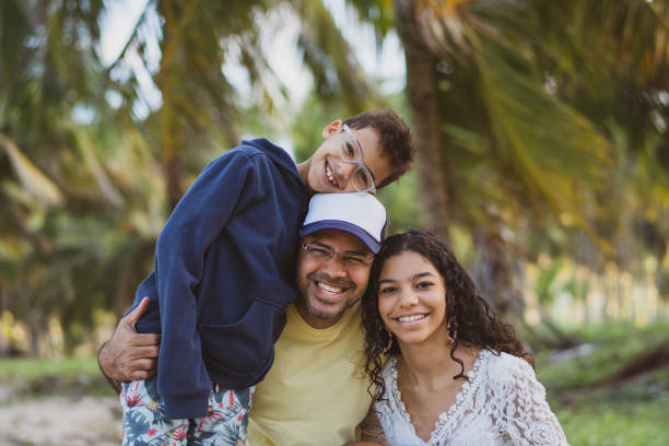 Father with his children looking at camera Father, Son, Daughter, Love - Emotion, Outdoors, Day 12 13 years photos stock pictures, royalty-free photos & images