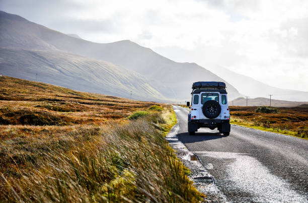 Landrover with rooftop tent en route on a road trip along the north coast 500. stock photo