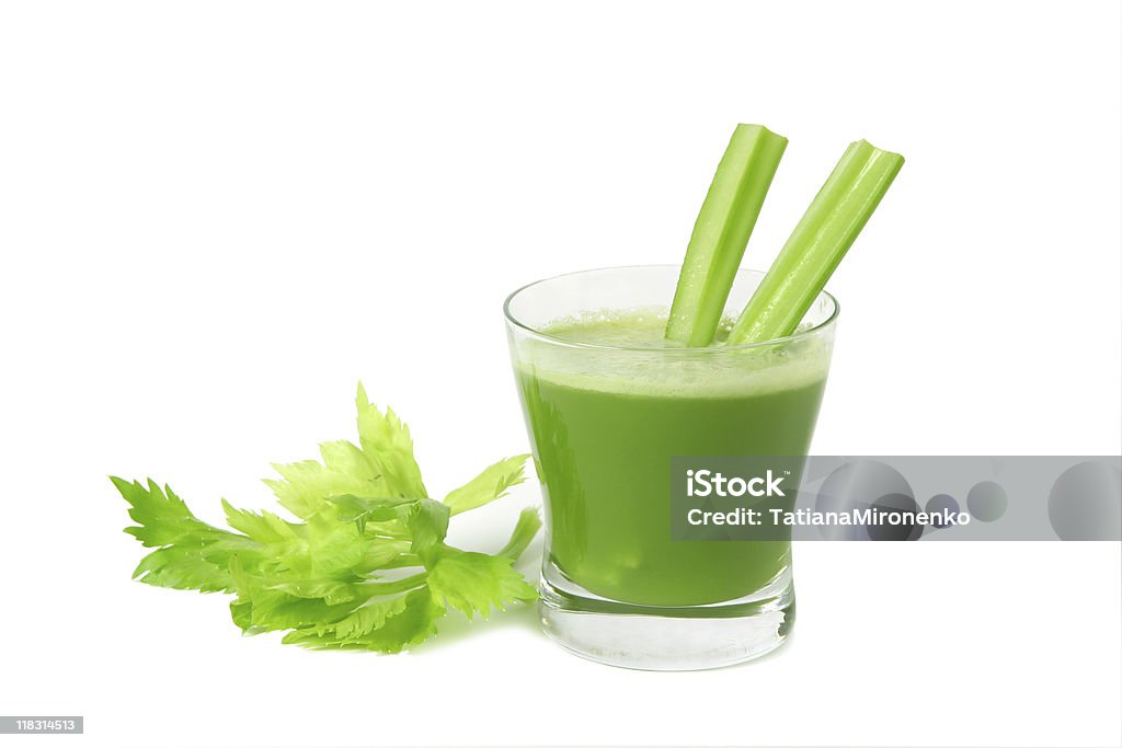 Freshly made bright green celery juice in a glass A glass of fresh vegetable celery juice  isolated on white background. Celery Stock Photo