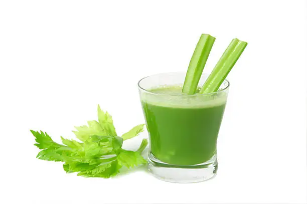 A glass of fresh vegetable celery juice  isolated on white background.