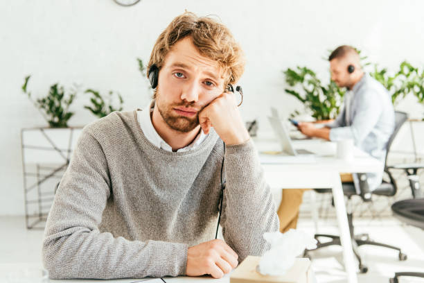 istock upset broker in headset near tissue box in office 1183147477
