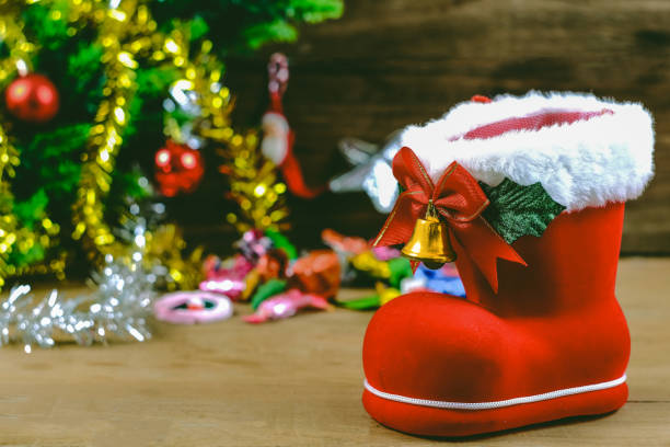 istock Red boot christmas or Santa's shoe on rustic wooden table,Christmas background. 1183147795