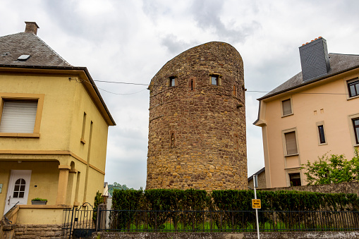 Fortified city wall tower between two houses in Echternach, Luxembourg, street view