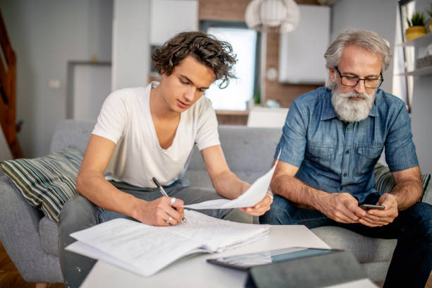istock Hispanic boy going through documents with his caucasian grandfather 1183149046