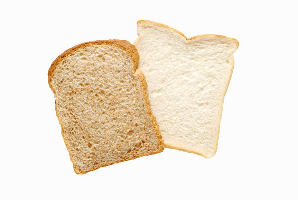 istock Two pieces of sliced bread, one white one brown whole wheat on white background 1183149272