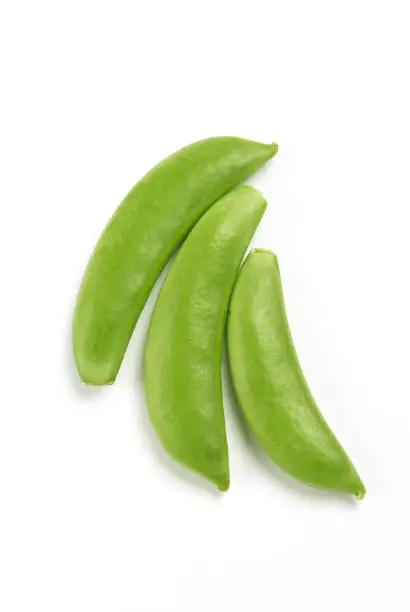 Three sugar snap pea pods on white background