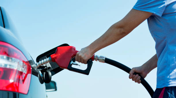 istock Man hand holding fuel pump and refilling car 1183150570