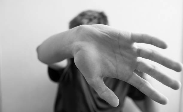 istock 18 years old guy protects himself with his hand 1183151858