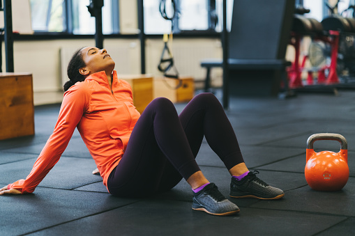 Mixed race woman resting after sports training
