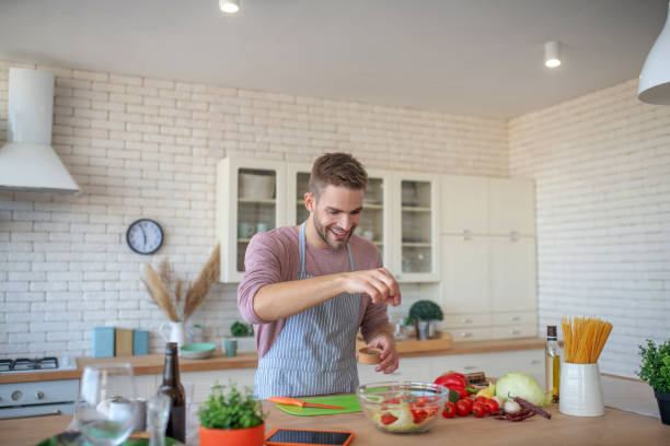 istock Cheerful man feeling good while cooking at home 1183154050