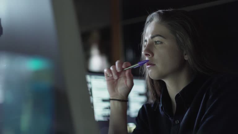 Woman monitor dark office