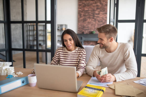 istock Husband looking at wife after counting profits from business 1183156367