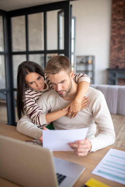 istock Wife hugging husband having some difficulties with business 1183156381