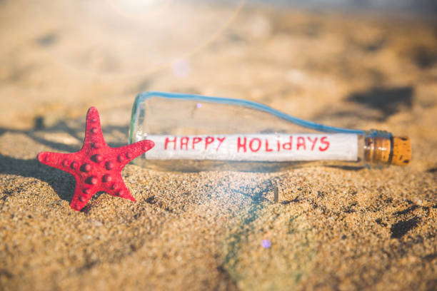 This is a side view close up color photograph of a Message in a Bottle on Sand dune at Sunset